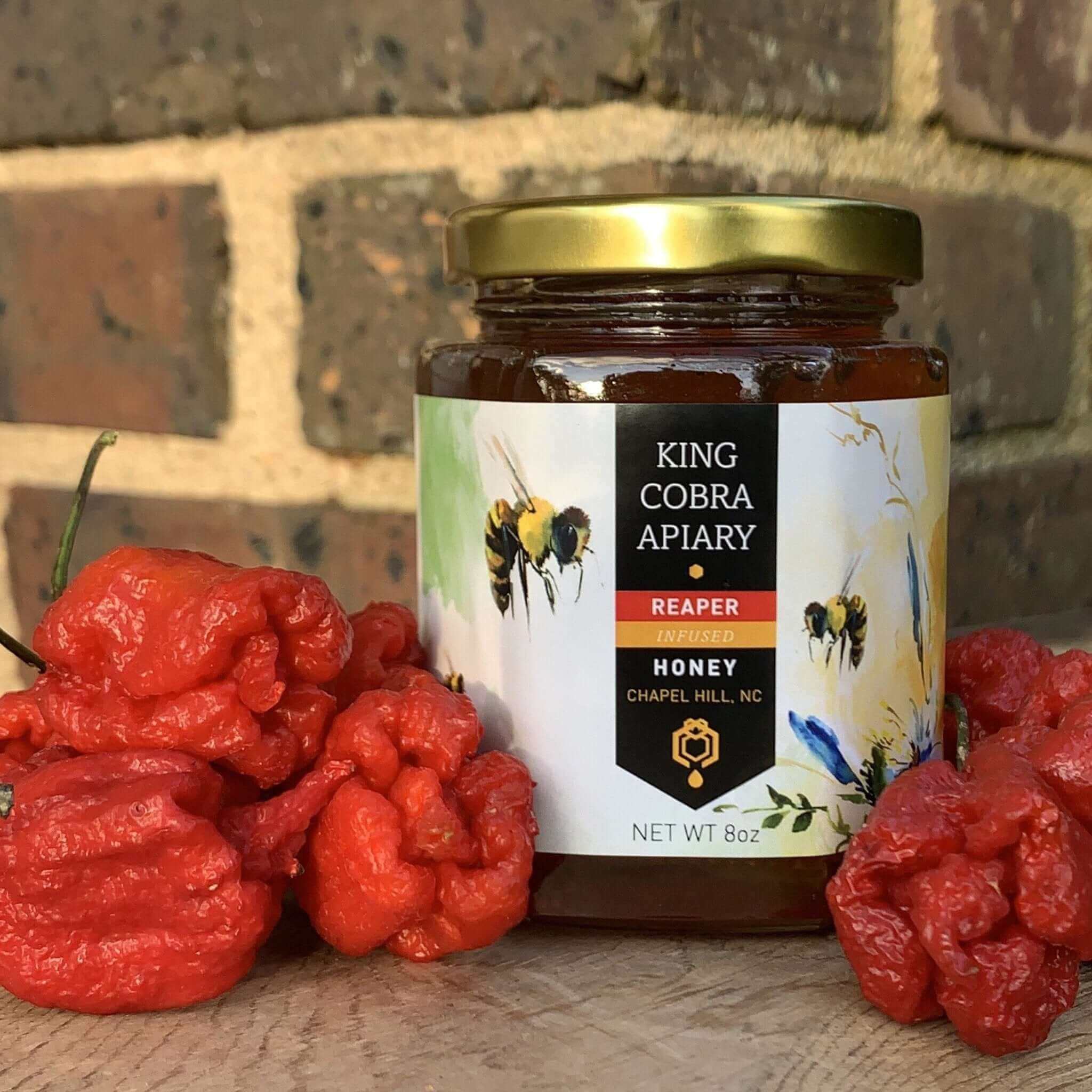 Infused Honey in a jar with red peppers, harvested from King Cobra Apiary in Chapel Hill, NC.