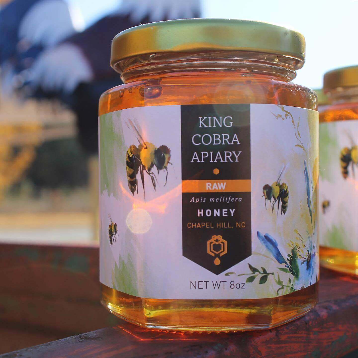Jar of King Cobra Apiary raw honey from Chapel Hill, NC, showcasing pure honey.